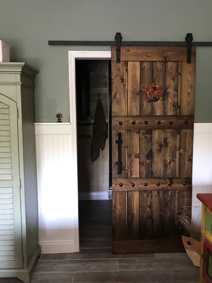 Rustic 84x33 Paneled Style Interior Barn Door in a room with a closet