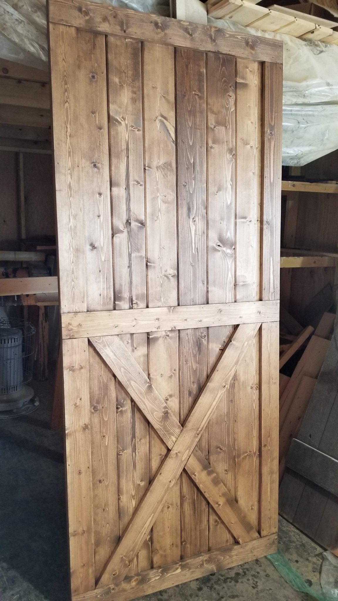 Full view of the Custom Bottom Brace Interior Barn Door with cross design