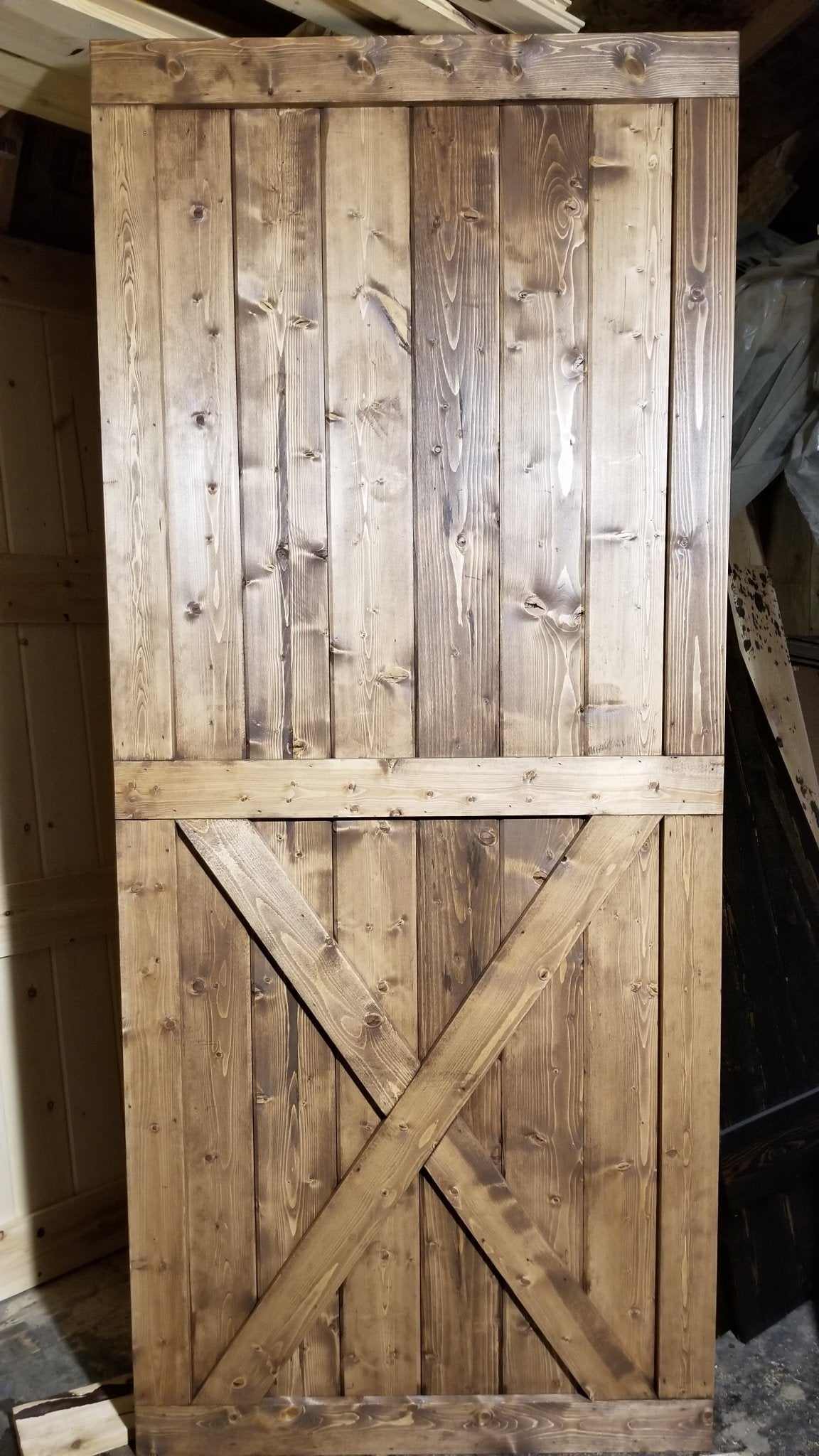 Detail view of the wooden cross on the Custom Bottom Brace Interior Barn Door