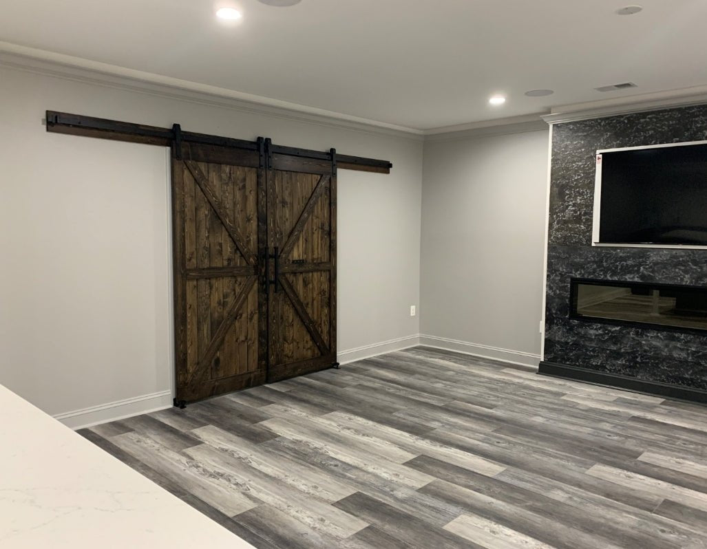 Living area with a fireplace and the Custom Double British Brace K Style Barn Door
