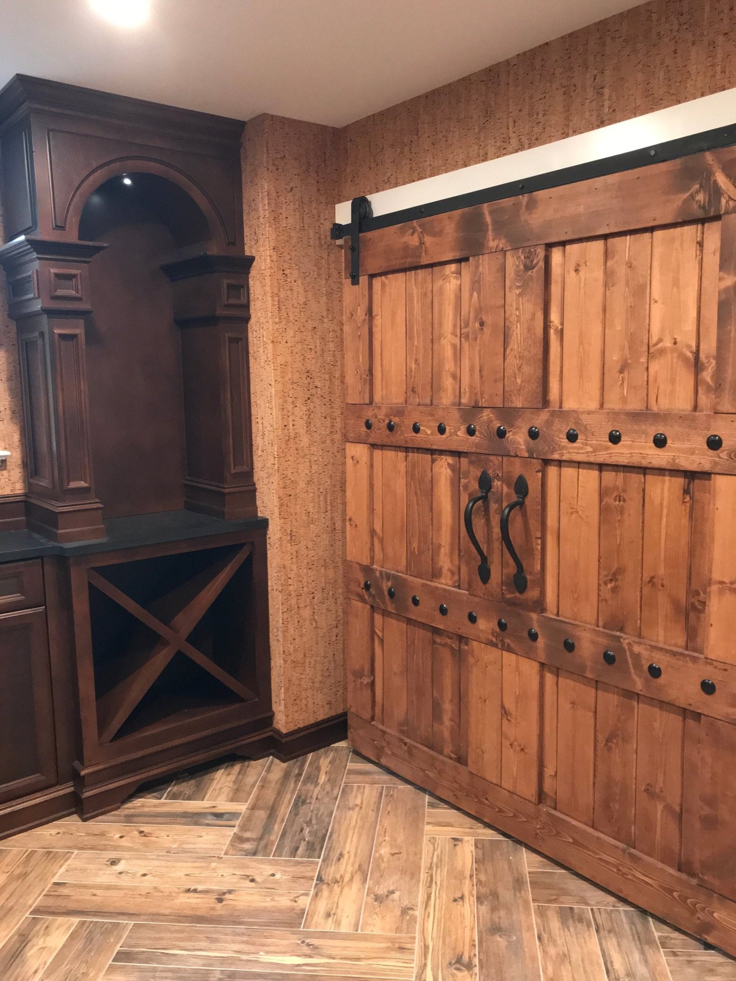 Custom Double Horizon Barn Door installed in a home with a wine rack