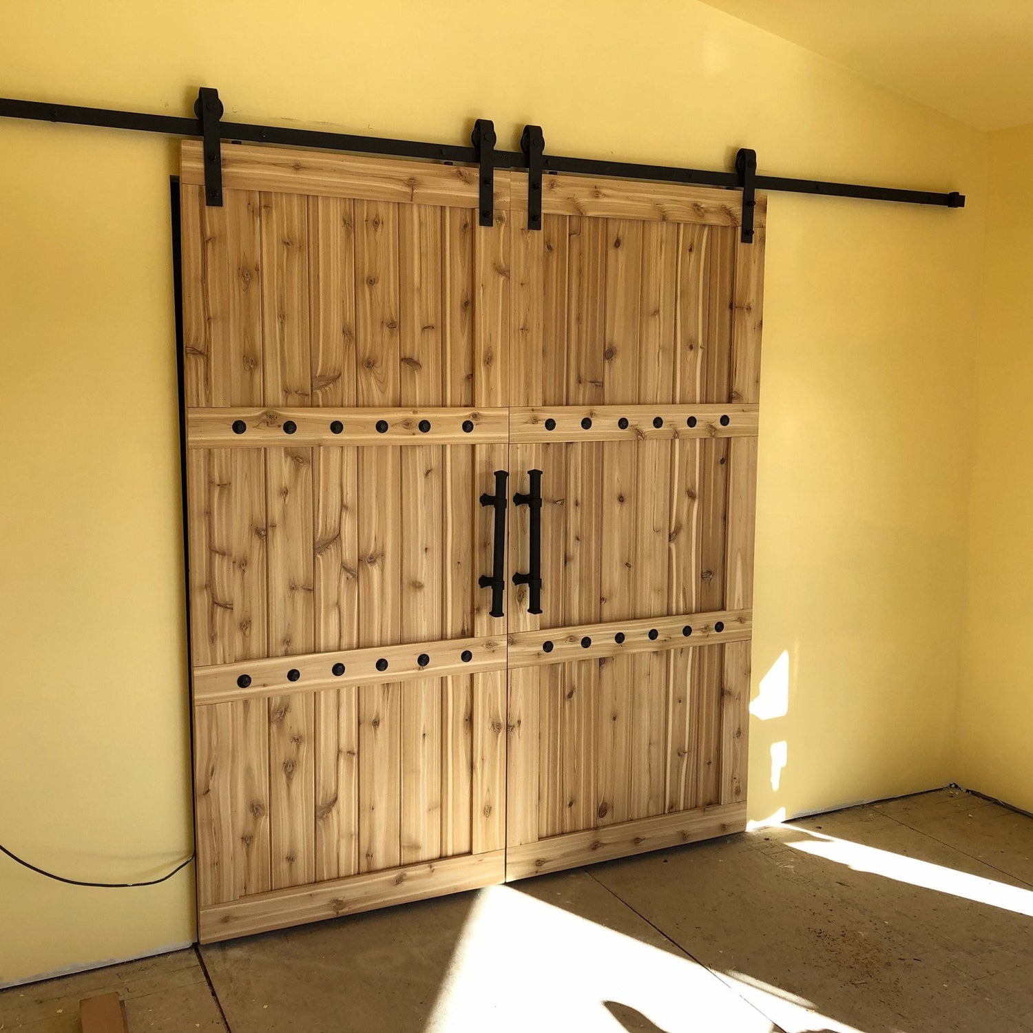 Room with a Custom Double Horizon Barn Door with two wooden panels
