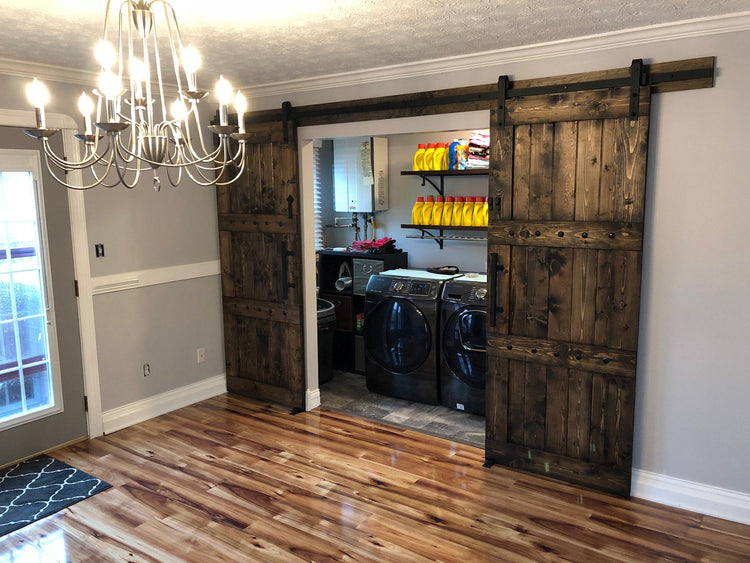 Laundry room featuring a Custom Double Horizon Barn Door with a washer and dryer