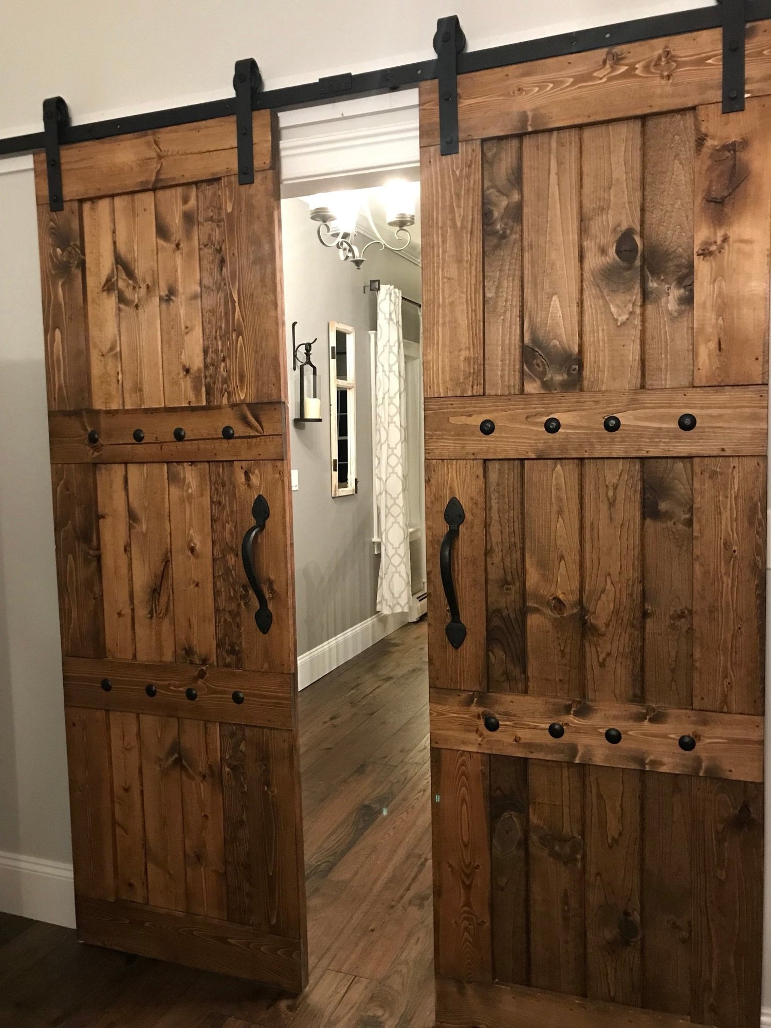 Pair of wooden barn doors equipped with black Customized Barn Sliding Hardware