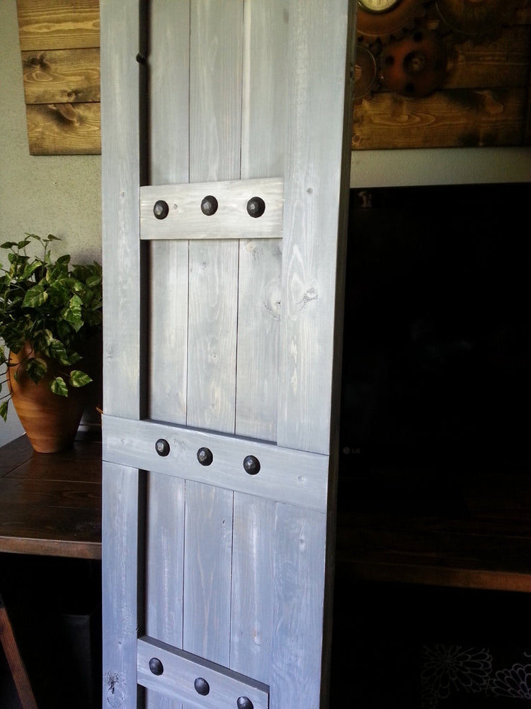 Wooden barn shutter with detailed metal hardware
