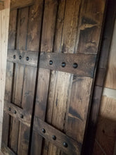 Pair of wooden barn shutters with metal hardware