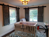 Nursery room with crib and wooden barn shutters