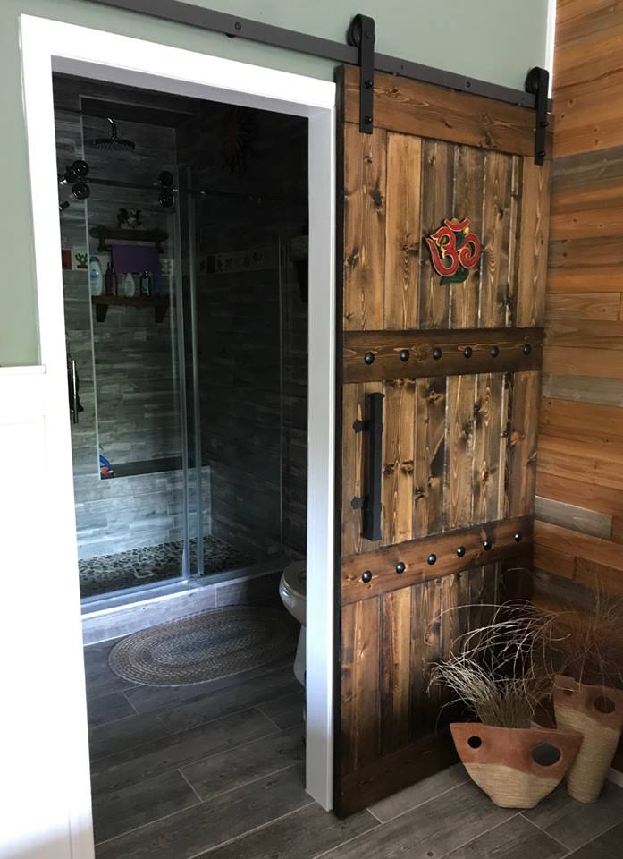 Bathroom featuring Rustic 84x33 Paneled Style Interior Barn Door and a shower