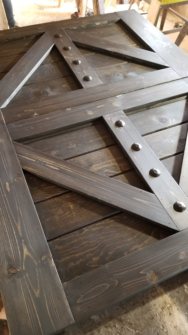 Close-up view of the wooden barn door with metal studs from the TV Hide package