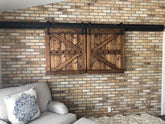 Living room setting featuring the TV Barn Door Package against a brick wall